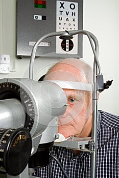 Older man having eye examination photo