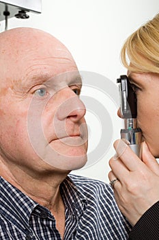 Older man having eye examination photo