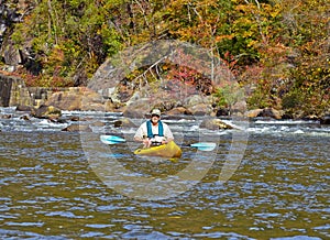 Older Man Kayaking in Autumn photo