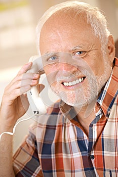 Older man on landline phone call photo