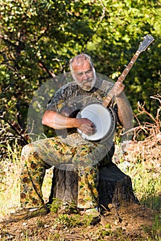 Older Man Playing the Banjo Outdoors