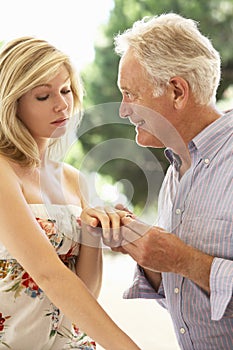 Older Man Proposing To Younger Woman photo