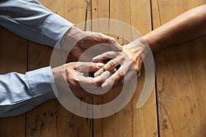 Older man putting engagement ring on woman finger close up