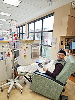 Older man in recliner receiving chemotherapy photo