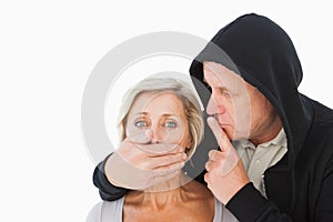 Older man silencing his fearful partner