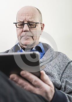 Older man on tablet pc photo