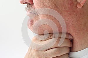 Older man with throat pain