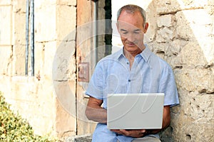 Older man using a laptop computer