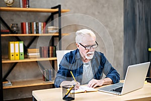 Older man using laptop for studying, working