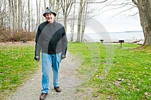 Older Man Walking in Park photo