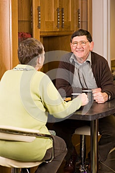 Older man and woman couple in kitchen