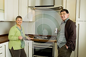 Older man and woman couple in modern kitchen