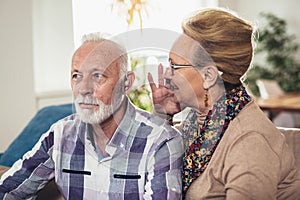 Older man and woman or pensioners with a hearing problem