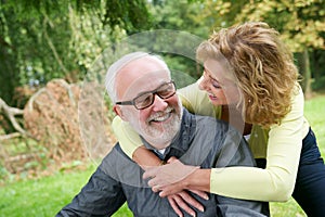 Older man and woman smiling outdoors