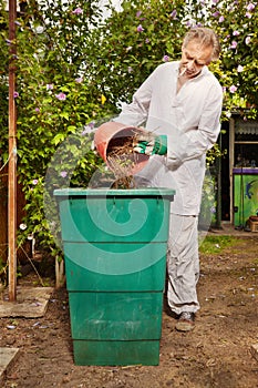 Older man working on his green bio garden on summer cottage