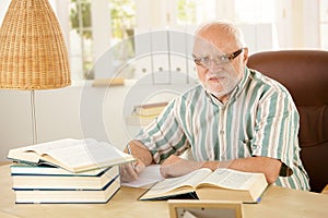 Older man working at his study