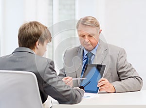 Older man and young man with tablet pc