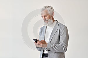 Old senior business man using smartphone standing isolated on white.