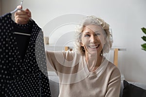 Older mature woman blogger demonstrating purchased jacket.