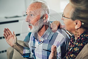 Man and woman or pensioners with a hearing problem photo