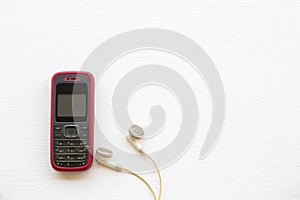 Older mobile phone press the button old generation with earphone