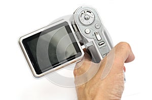 An older model of a handy cam held in the hand