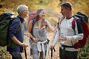 Older parents hiking with daughter; Quality family time concept