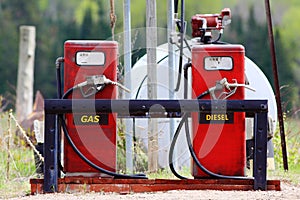 Older red gas pumps with diesel and gas