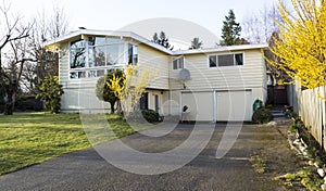 Older Single Family Home with large Driveway in Early Spring Sea