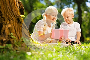 Older sister explaining something to a little brother