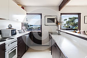 Older style retro 70s kitchen in Australian beach house photo