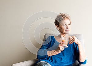 Older woman with cup of tea looking pensive