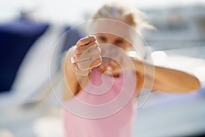 Older woman doing shadow boxing outdoors. Senior female doing sport in a coastal port