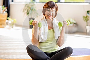 Older woman doing yoga indoors