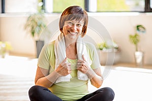 Older woman doing yoga indoors