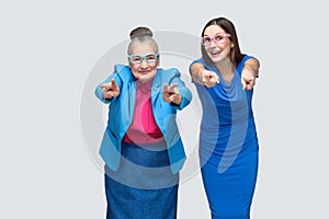 Older woman with grandchild pointing fingers at camera
