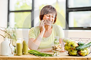 Older woman with healthy food indoors