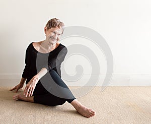 Older woman laughing doing yoga