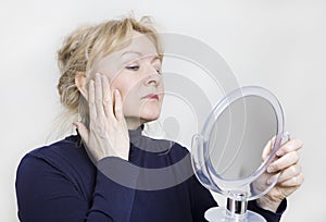 Older woman looking in mirror