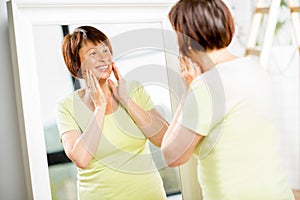 Older woman looking into the mirror