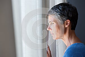 Older woman looking out window