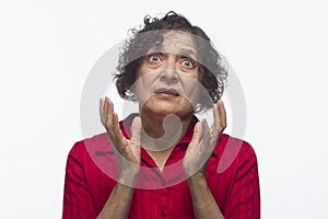 Older woman looking up in disbelief, horizontal