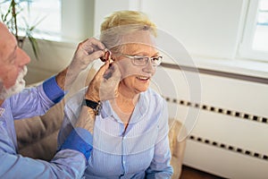 Woman and man or pensioners with a hearing problem photo