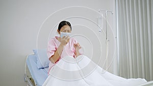 Older Woman in mask coughing from her lungs infected with COVID-19
