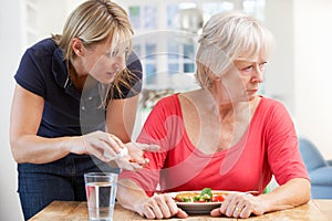 Older woman refusing medication