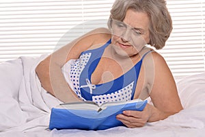 Older woman resting in the bedroom