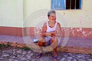 Older Woman Sitting on Curb in Trinidad, Cuba