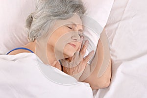 Older woman sleeping in the bedroom
