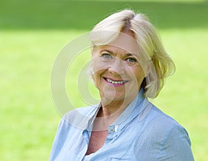 Older woman smiling outside