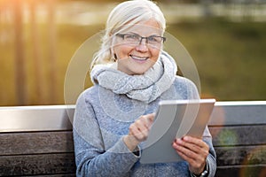 Older woman using digital tablet photo